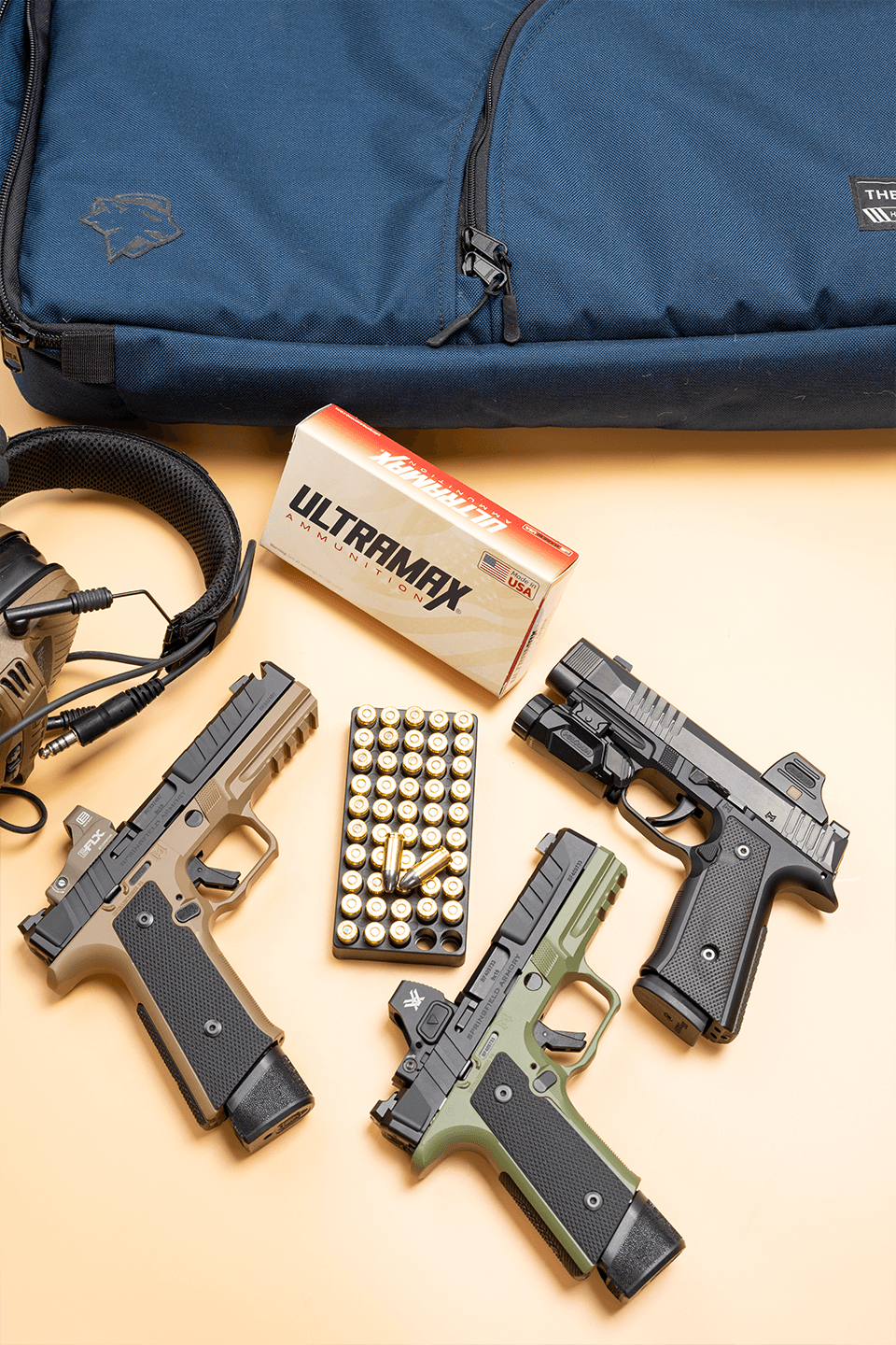 Close-up of ULTRAMAX brass centerfire cartridges on a dark tactical surface